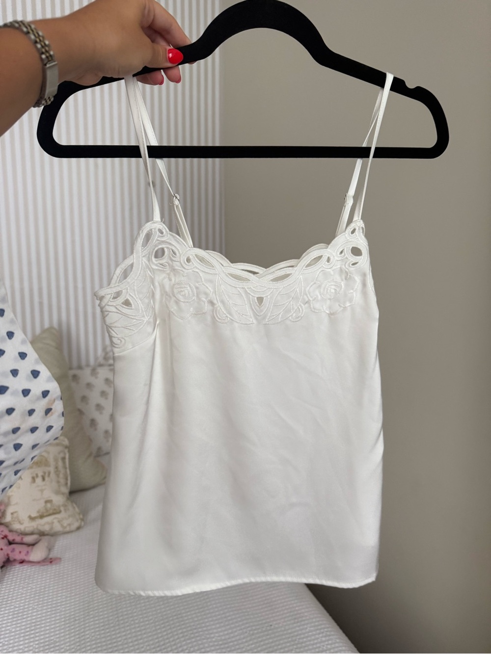 white silk camisole features delicate scalloped embroidery across the neckline